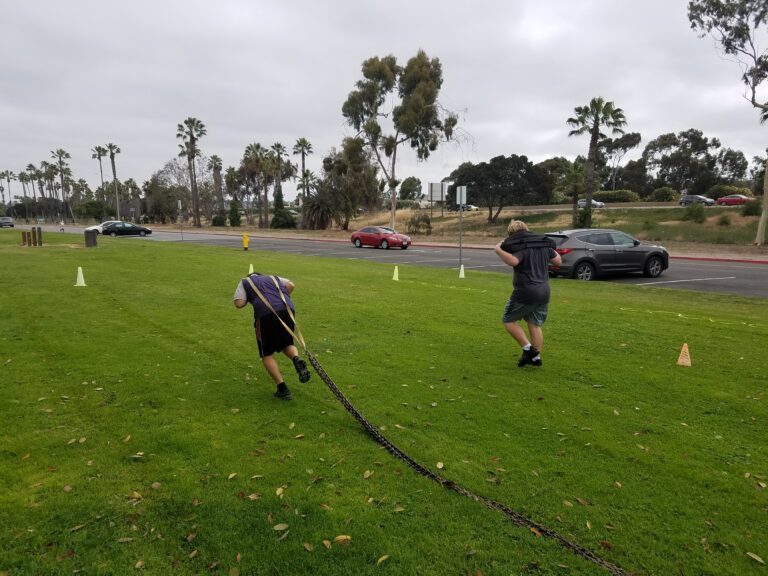 Youth athletes performing outdoor strength and conditioning drills at a San Diego park